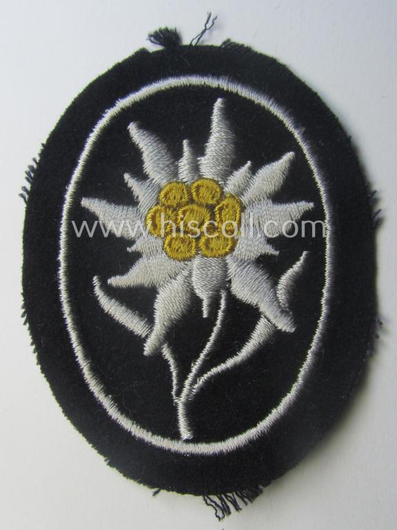 Waffen-SS-pattern, black-coloured sleeve-insignia (ie. 'Ärmelabzeichen') depicting an: 'Edelweiss'-flower as used by the various 'Gebirgsjäger'- (ie. mountain-troops-) related divisional-staff