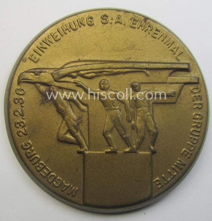 Commemorative SA- (ie. 'Sturmabteilungen'-) related 'tinnie' being a non-maker-marked example showing three sportsmen and eagle-statue coupled with the text: 'Einweihung S.A.-Ehrenmal der Gruppe Mitte - Magdeburg - 23.2.1936'