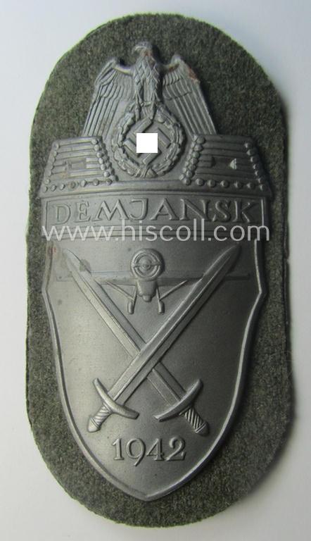 Superb, WH (Heeres ie. Waffen-SS) 'Demjansk'-campaign-shield as executed in typical magnetic metal (ie. so-called: 'Eisenblech') and that comes in an overall very nice- ie. fully untouched-, condition
