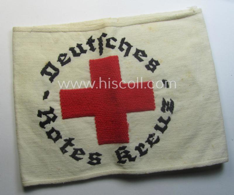 Linnen-based- and/or neatly 'machine-embroidered', beige-white-coloured DRK- (ie. 'Deutsches Rotes Kreuz'-) armband (ie. 'Armbinde') as was intended for the staff-members serving with the: 'Deutsches Rotes Kreuz' (or: German Red Cross)