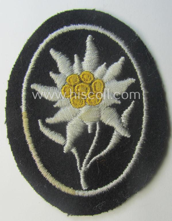 Waffen-SS-pattern, black-coloured sleeve-insignia (ie. 'Ärmelabzeichen') depicting an: 'Edelweiss'-flower as used by the various 'Gebirgsjäger'- (ie. mountain-troops-) related divisional-staff