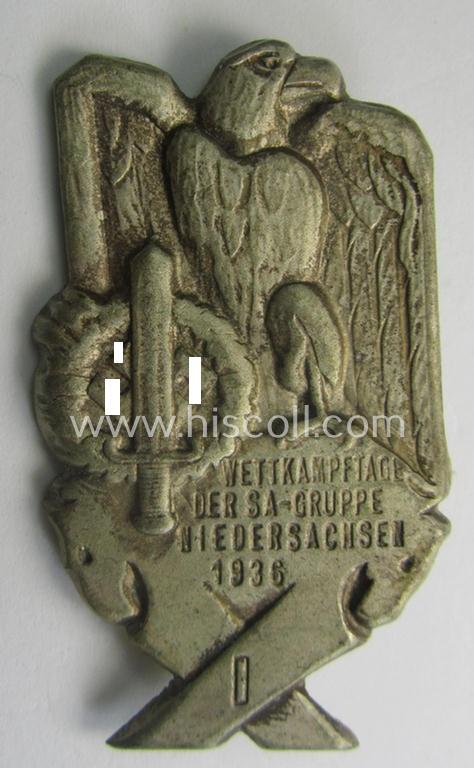 Commemorative,  tin-based SA- (ie. 'Sturmabteilungen'-) related 'tinnie', being a non-maker-marked- and 'hollow-back' example depicting an eagle-device and SA-sports'-badge and the text: 'SA-Wettkampftage der SA-Gruppe Niedersachsen - 1936'
