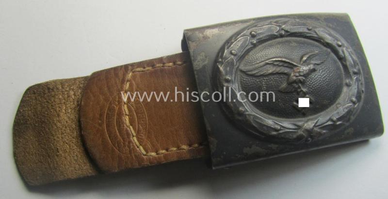 WH (Luftwaffe) bluish-grey-coloured, steel-based belt-buckle being a maker- (ie. 'R. Sieper & Söhne'-) marked example that comes mounted onto its leather-based tab