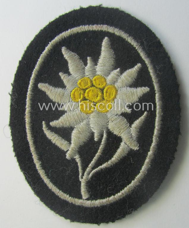 Waffen-SS-pattern, black-coloured sleeve-insignia (ie. 'Ärmelabzeichen') depicting an: 'Edelweiss'-flower as used by the various 'Gebirgsjäger'- (ie. mountain-troops-) related divisional-staff