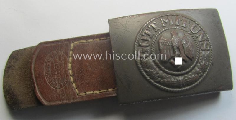 Moderately used, WH (Heeres) field-grey-coloured- and/or steel-based belt-buckle being a non-maker-marked example that comes mounted onto its maker- (ie. 'F.W. Assmann - Lüdenscheid'-) marked and/or '1940'-dated leather-based tab