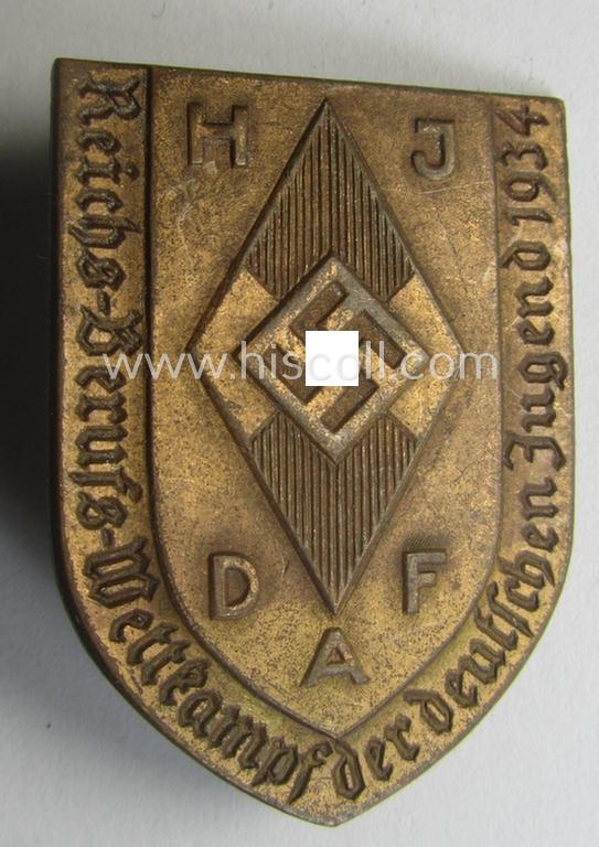 Commemorative, golden-bronze-toned, 'DAF'/'HJ'- (ie. 'Deutsches Arbeits Front o. Hitlerjugend'-) related 'tinnie' being a maker- (ie. 'Reichsverband 58 Pforzheim'-): 'Reichs-Berufs-Wettkampf der deutschen Jugend 1935'