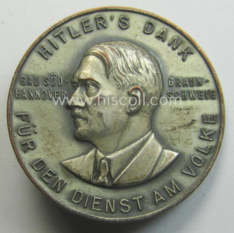 Commemorative, silvered 'Buntmetall'-based N.S.D.A.P.- (ie. WHW-) related 'tinnie' being a maker- (ie. 'Paulmann u. Crone'-) marked example depicting A.Hitler and text: 'Hitlers' Dank für den Dienst am Volke - Gau Süd-Hannover - Braunschweig'
