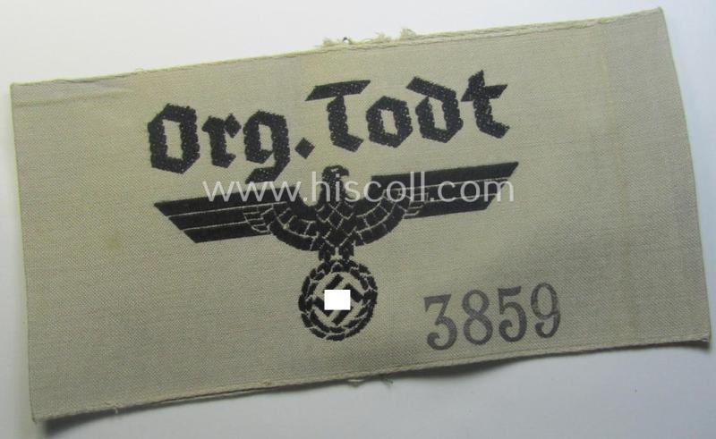 Superb - and rarely seen! - OT- (ie.: 'Organisation Todt'-) related, greyish-coloured and 'BeVo'-woven armband (ie. 'Ärmbinde') showing a detailed eagle-device and depicting the text: 'Org.Todt.' (and printed serial-number: '3859')