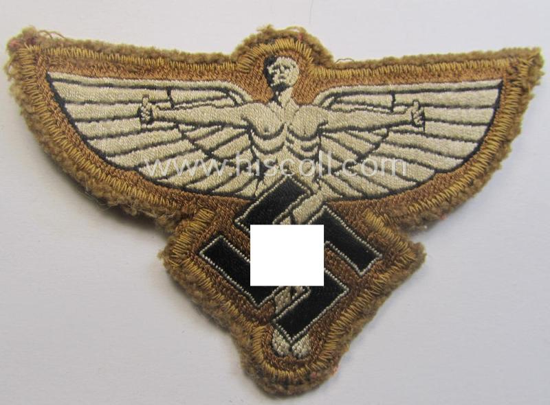 Beige-tan-coloured, so-called: N.S.F.K.- (or: 'National Socialistisches Flieger Korps') breast-eagle being a nicely woven- (and enlisted-mens'-pattern) example that comes mounted on its piece of tan-coloured linnen