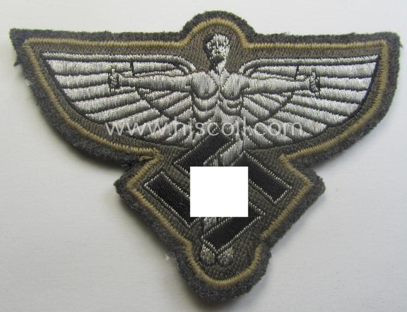 Bluish- (ie. silver-) coloured, so-called: N.S.F.K.- (or: 'National Socialistisches Flieger Korps') breast-eagle being a nicely woven- (and officers'-pattern) example that comes mounted on its piece of bluish-grey-coloured linnen