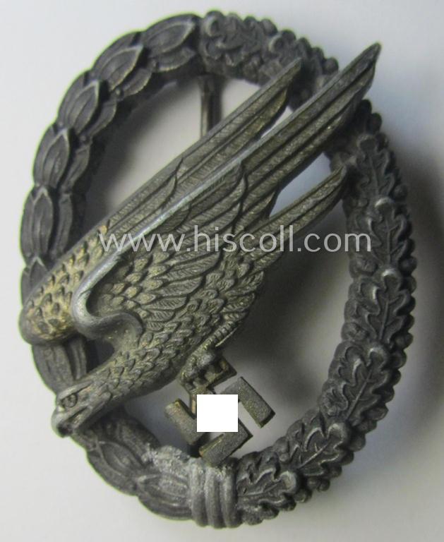 Zinc- (ie. 'Feinzink'-) based version of a WH (Luftwaffe) 'Fallschirmschützen-Abzeichen' (being a maker-marked, 'Type A'-pattern example as was produced by the 'G.H. Osang'-company)