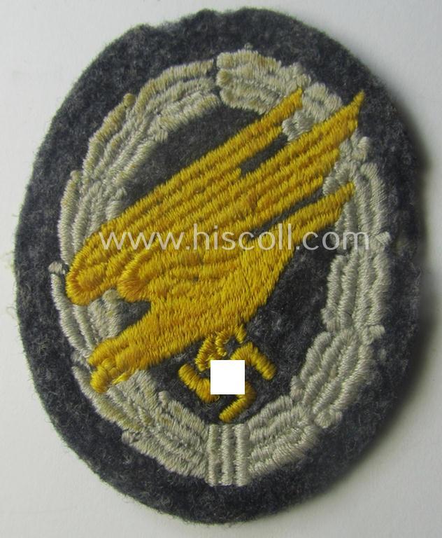 Truly used- and/or carefully tunic-removed, WH (Luftwaffe) 'Fallschirmschützen-Abzeichen in Stoff' (or: cloth-based paratroopers'-jump-badge) being a nicely machine-embroidered specimen that comes in a just moderately used- ie. worn, condition