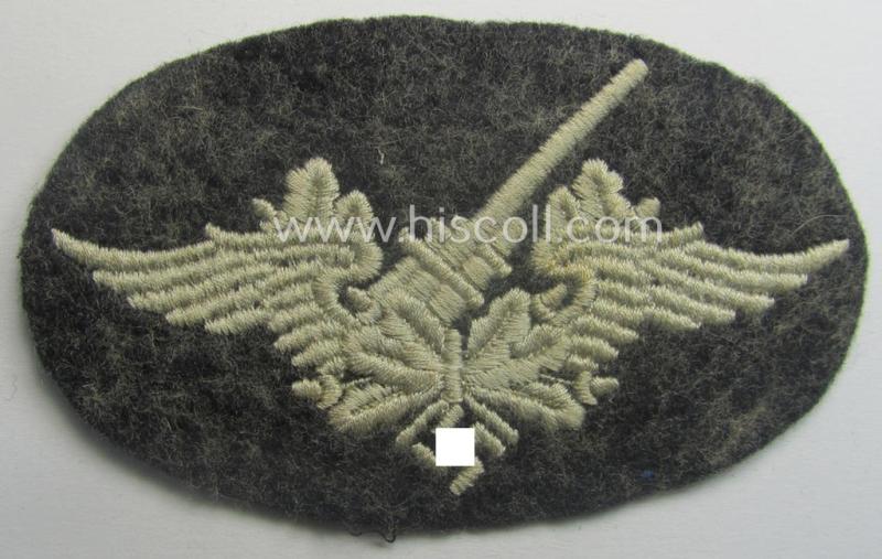 Machine-embroidered WH (Luftwaffe) trade- ie. special-career-patch as was intended for: 'Flak-Artillerie'-staffmembers and that comes in a probably issued but never worn- (ie. 'virtually mint'-), condition