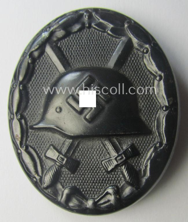 Nicely maker- (ie. '107-) marked example of a black-class wound-badge (or: 'Verwundeten-Abzeichen in Schwarz') being an example that was produced by the maker (ie. 'Hersteller') named: 'Carl Wild'