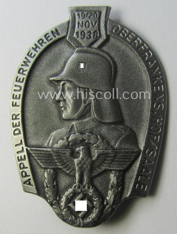 Commemorative, hollow-back- and/or silverish-grey-toned, so-called: 'Feuerwehr'-related day-badge (ie. 'tinnie') as executed in zinc-based-metal that is showing the text: 'Appell der Feuerwehren Oberfrankens - Hof/Saale - 19./20. November 1938'