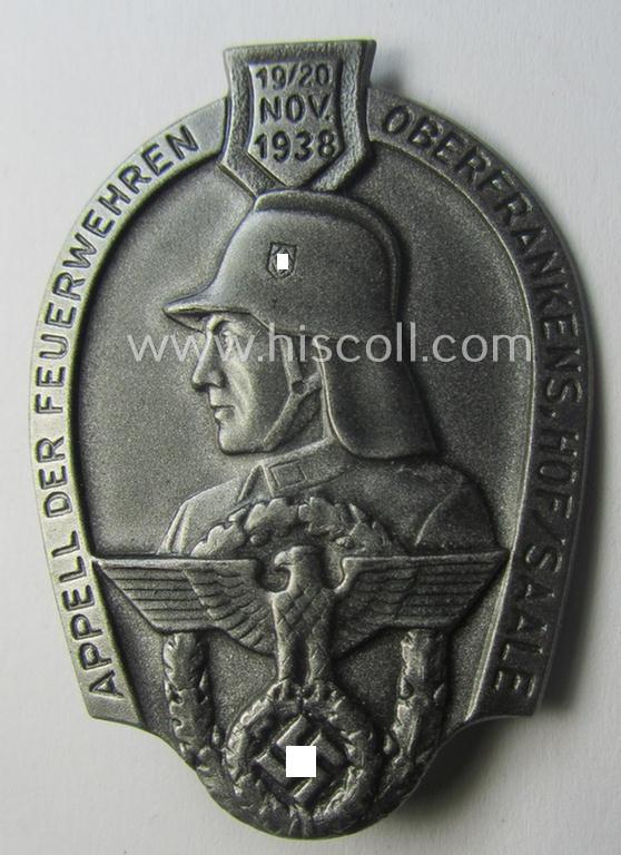 Commemorative, hollow-back- and/or silverish-grey-toned, so-called: 'Feuerwehr'-related day-badge (ie. 'tinnie') as executed in zinc-based-metal that is showing the text: 'Appell der Feuerwehren Oberfrankens - Hof/Saale - 19./20. November 1938'