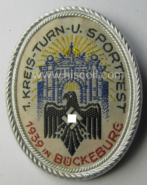 Commemorative - tin- (ie. linnen-) based, DRL- (ie. 'Deutschen Reichsbund für Leibesübungen'-) related day-badge ie. 'tinnie' being a non-maker-marked example depicting the DRL-logo and text: '1. Kreis- Turn- u. Sportfest - 1939 in Bückeburg'