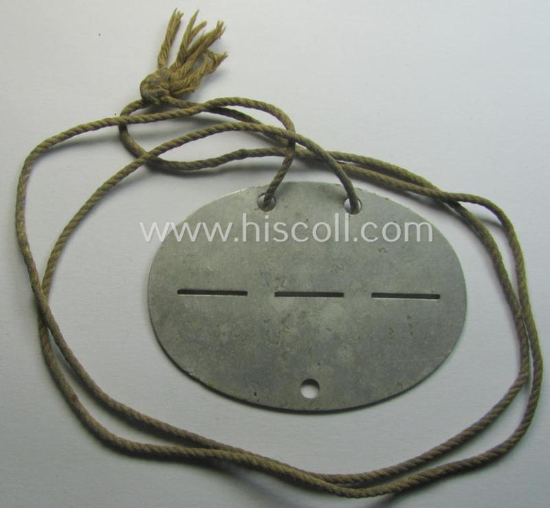 Aluminium-based, WH (Heeres) (ie. 'Infanterie-Geschütz-Ersatz'-related) ID-disc bearing the clearly stamped unit-designation that simply reads: 'Inft.Gesch./Ers./Kp.16' and that comes still mounted onto its (period-attached) cord