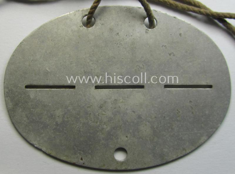 Aluminium-based, WH (Heeres) (ie. 'Infanterie-Geschütz-Ersatz'-related) ID-disc bearing the clearly stamped unit-designation that simply reads: 'Inft.Gesch./Ers./Kp.16' and that comes still mounted onto its (period-attached) cord