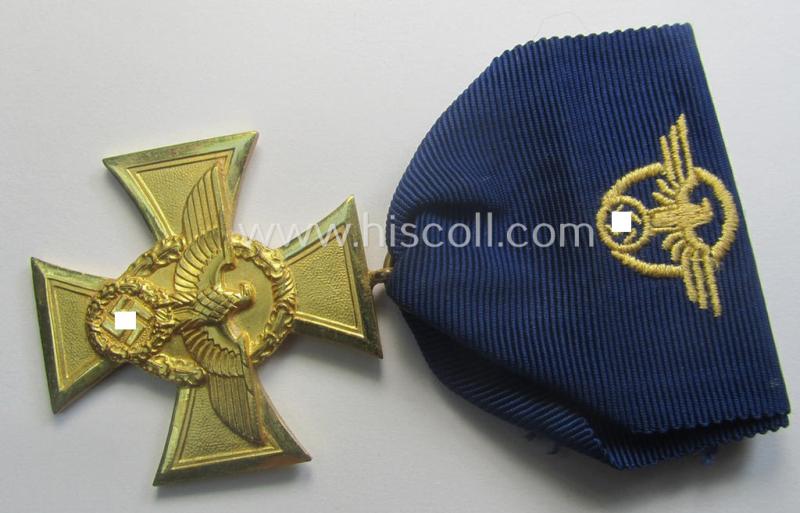 Golden-class 'Pol.-Dienstauszeichnung 1. Stufe' (or: police loyal-service medal first-class) that comes mounted onto its (typically broader-shaped!) ribbon (ie. 'Bandabschnitt')