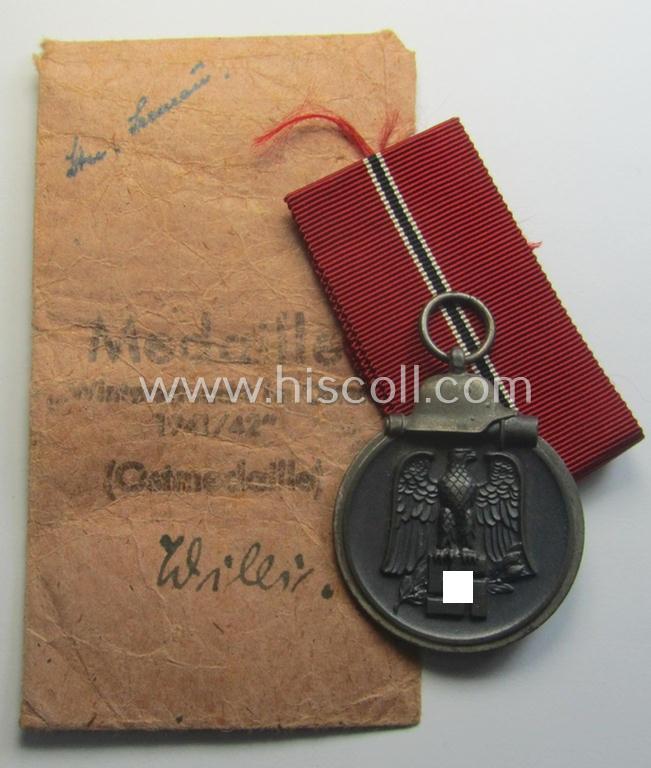 Fully matching medal-set: 'Winterschlacht im Osten 1941/42' as produced by the: 'Hauptmünzamt - Wien'-company being a clearly maker- (ie. '30'-marked) specimen that came stored in its original 'Zellstoff'-based pouch of issue as found