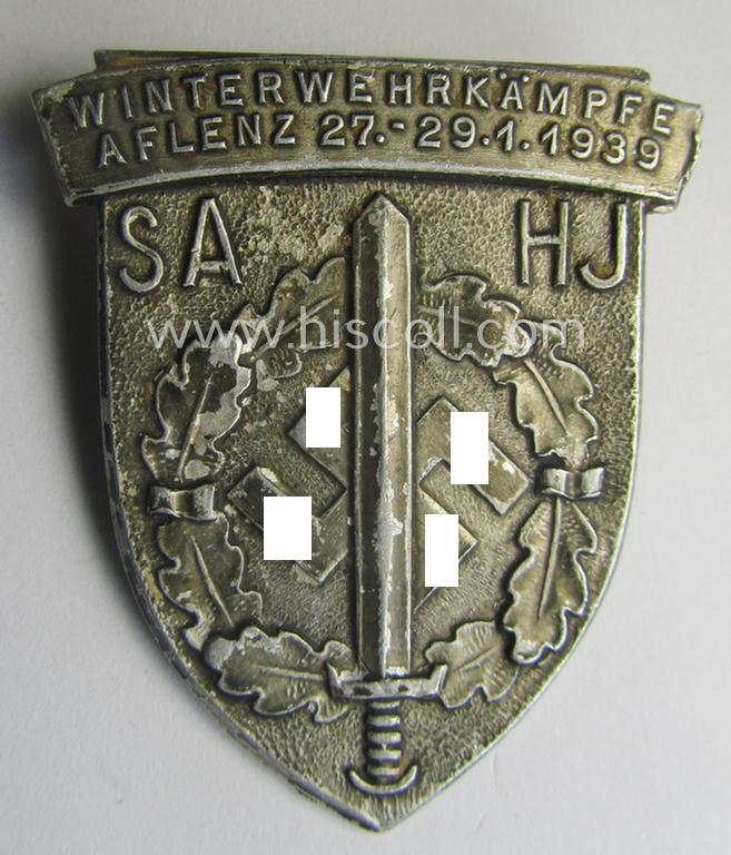 Commemorative, aluminium-based SA- o. HJ (ie. 'Sturmabteilungen'-) related 'tinnie' being a maker-marked example showing an 'SA-Sportabzeichen' and text: 'Winterwehrkämpfe - Aflenz - 27.-29.-1.1939'