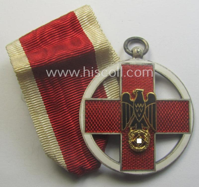 Superb, 'DRK-Ehrenzeichen des 3. Modell' that comes together with its original (regular-sized- and once-mounted) ribbon (ie. 'Bandabschnitt') as issued and/or stored for decades