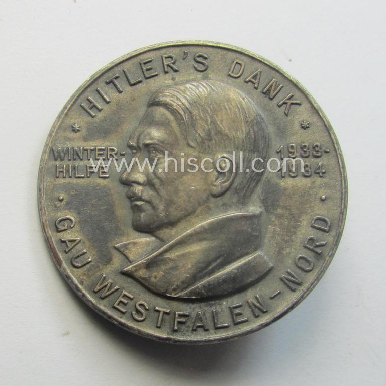 Commemorative - zinc-based- and/or silver-coloured - N.S.D.A.P.- (ie. WHW-) related 'tinnie', being a maker- (ie. 'Paulmann u. Crone'-) marked example depicting a portrait of Adolf Hitler surrounded by the text: 'Hitlers' Dank - Gau Westfalen Nord'