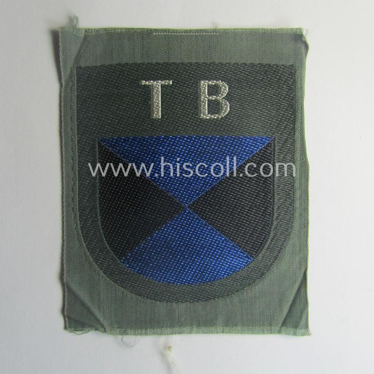 Eastern- ie. Russian volunteer (ie. Cossack-) related armshield as executed in the neat 'BeVo'-weave pattern depicting the interwoven 'Cyrillic' characters: 'TB' (as was intended for the Russian volunteers serving within the 'Terek Cossacks')