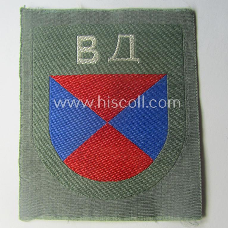 Eastern- ie. Russian volunteer (ie. Cossack-) related armshield as executed in the neat 'BeVo'-weave pattern depicting the interwoven 'Cyrillic' characters: 'BA' (as was intended for the Russian volunteers serving within the 'Don Cossacks')