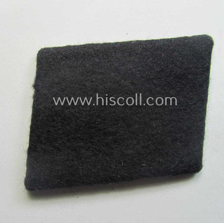 Waffen-SS EM-pattern rank-collar-rank-tab ('Kragenspiegel') being a 'standard-issue'-pattern example as executed in black-coloured wool as was intended for usage by an: 'SS-Mann'