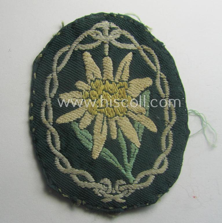 Truly used and/or tunic-removed, WH (Heeres) EM- (ie. NCO-) type, so-called: 'Edelweiss'-armpatch being a 'BeVo'-woven example as was executed on darker-green linnen as was specifically intended for usage by the: 'Gebirgsjäger-Trp.'