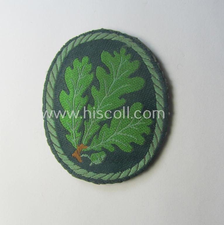 Truly used- and/or worn, WH (Heeres) EM- (ie. NCO-) type, so-called: 'Jäger'-armpatch being a (typical) 'BeVo'-woven example as was executed on field-grey-coloured linnen as was intended for usage by the: 'Jäger-Trpn.'