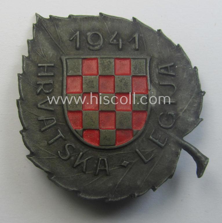 Truly used- and/or worn and/or typical 'Feinzink'-based cap-shield (ie. 'Mützenschild') entitled: 'Hrvatska-Legija 1941' as was intended for usage by a volunteer who served within the 'Deutsche Wehrmacht' ie. within the 'Kroatische Legion'